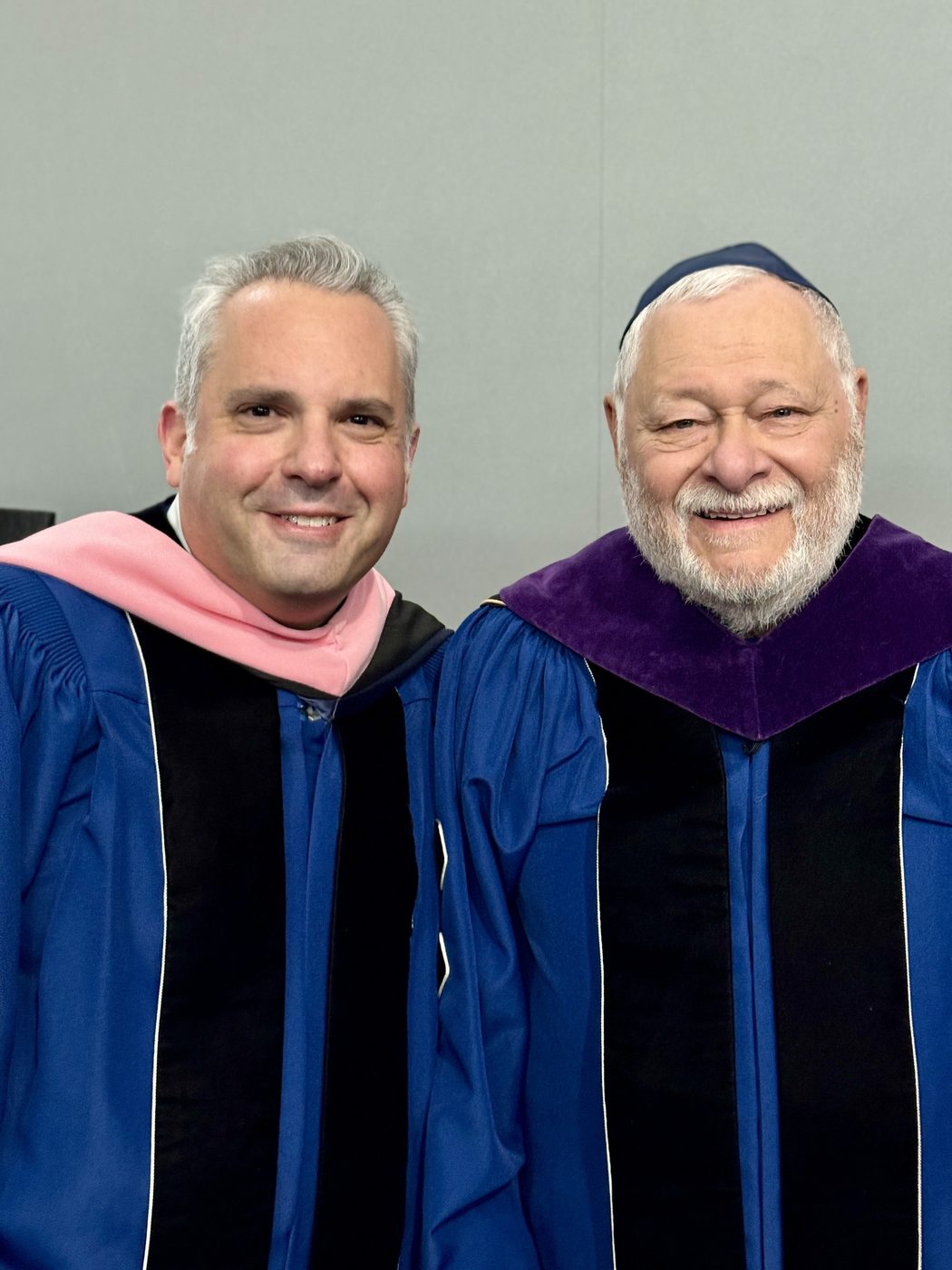 Gideon Zelermyer and Stephen Joel Trachtenberg, both in blue academic robes, at the 2023 inauguration.