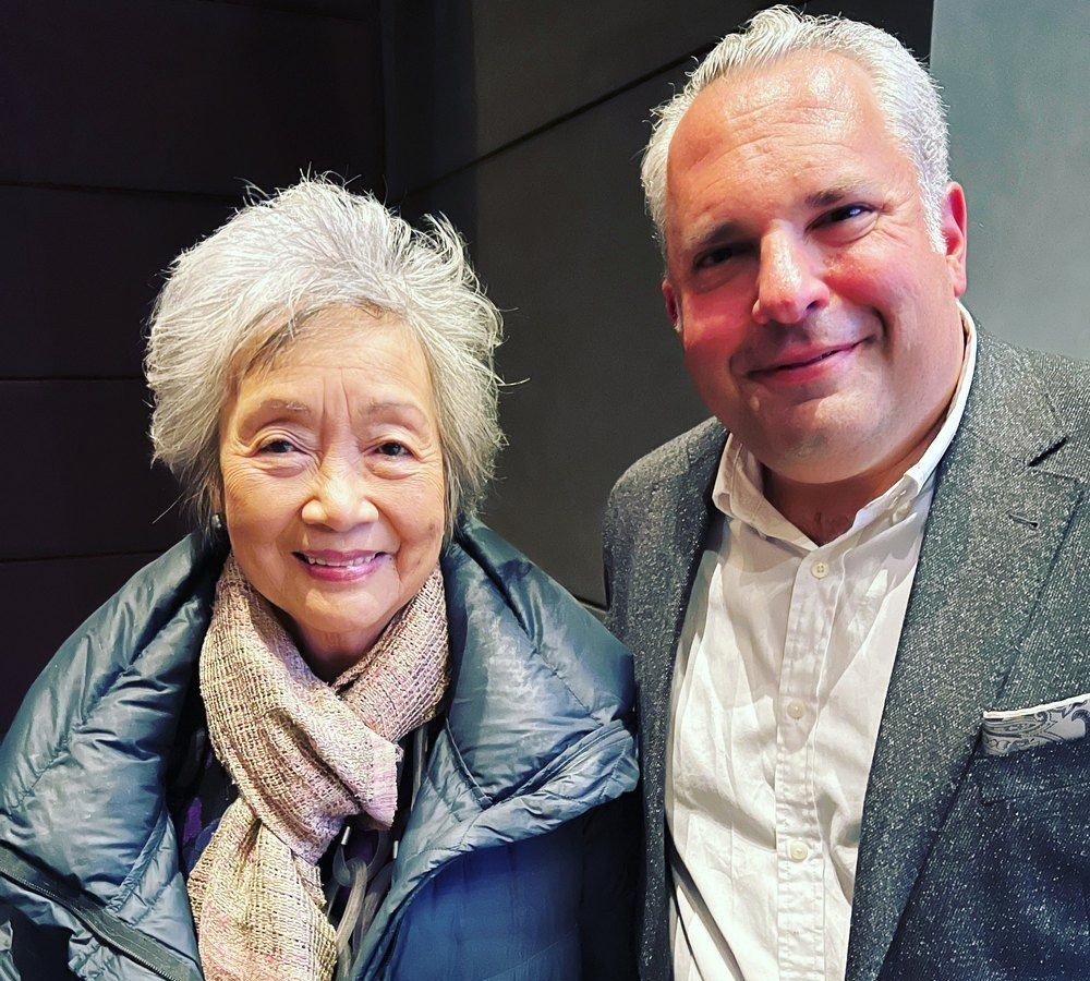 Gideon Zelermyer and Adrienne Clarkson standing side by side, smiling, at the Art Gallery of Ontario.