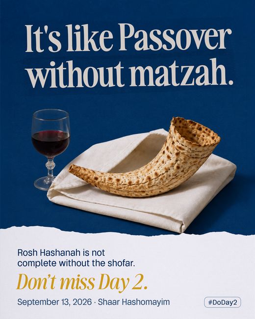 A shofar baked from matzah, resting on a folded white napkin beside a glass of red wine on Shaar navy.