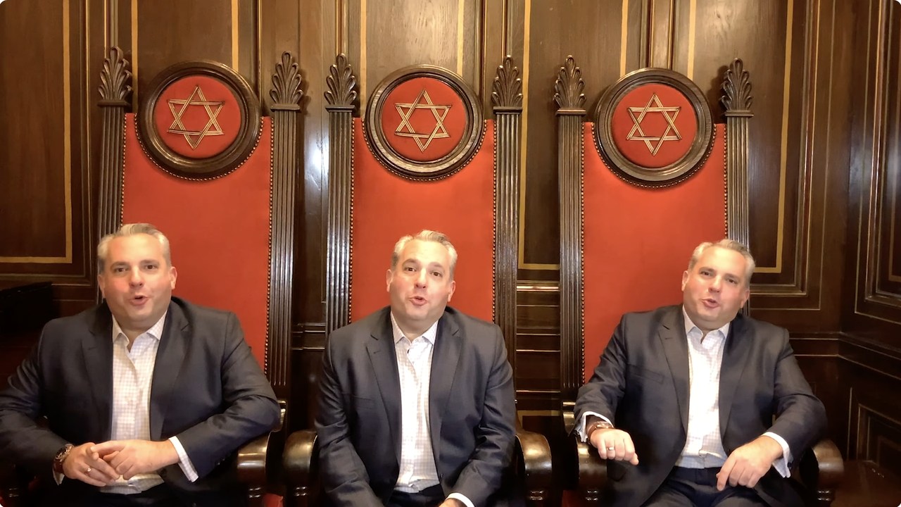 Zelermyer multiplied three times, sitting in the three high-backed red and carved-wood chairs on the Shaar Hashomayim bimah, each with a Star of David above him, all three singing.