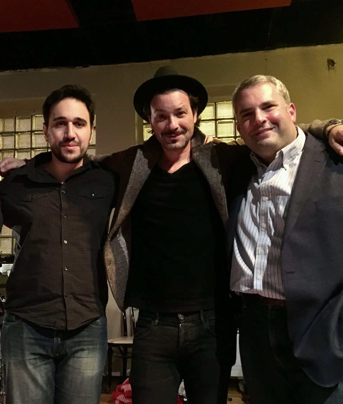 Roï Azoulay, Adam Cohen and Gideon Zelermyer standing together in the studio, arms around one another.