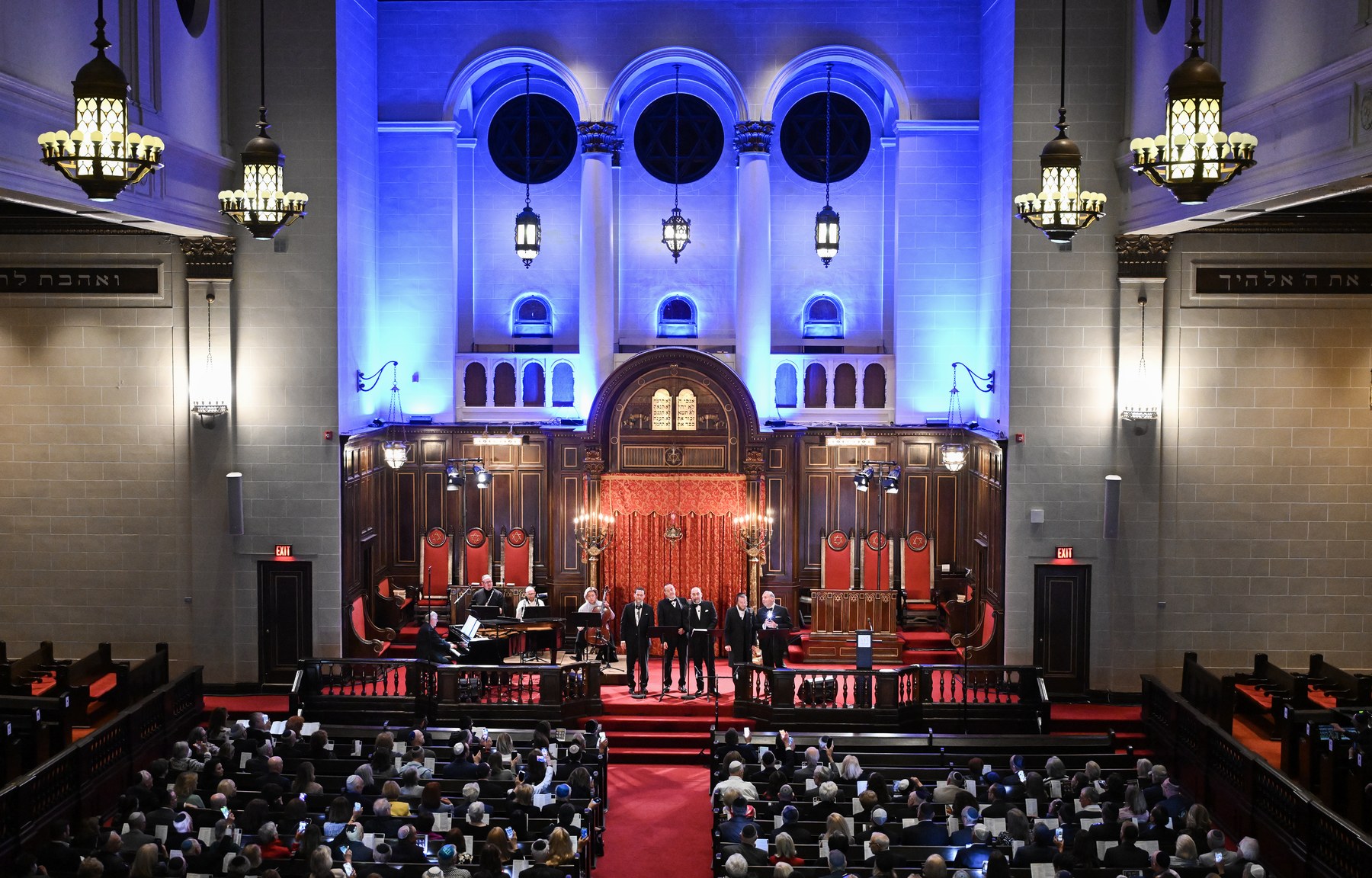 The main sanctuary from the balcony, lit blue, a full house below.